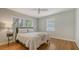 Relaxing bedroom features hardwood floors, natural light, a ceiling fan, and neutral decor at 1931 Bahia Vista St, Sarasota, FL 34239