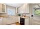 Bright kitchen features white cabinetry, countertops, a modern sink, and stainless steel appliances at 1931 Bahia Vista St, Sarasota, FL 34239