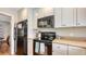 Functional kitchen with black appliances, light countertops, and modern white cabinets at 1931 Bahia Vista St, Sarasota, FL 34239