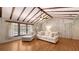 Cozy living room featuring beamed vaulted ceilings, hardwood floors, and comfortable furnishings at 1931 Bahia Vista St, Sarasota, FL 34239