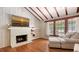 Living room featuring fireplace, shelving, hardwood floors, and an abundance of natural light at 1931 Bahia Vista St, Sarasota, FL 34239