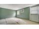 Unfurnished room with green walls, two windows, and an exterior door at 1931 Bahia Vista St, Sarasota, FL 34239