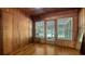 Inviting sunroom features wood paneling, hardwood flooring, and glass doors leading to the outdoors at 1931 Bahia Vista St, Sarasota, FL 34239