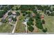 Wide aerial perspective of home with surrounding land and mature trees at 2040 Edmondson Rd, Nokomis, FL 34275
