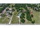 Establishing aerial shot of home and property surrounded by large trees at 2040 Edmondson Rd, Nokomis, FL 34275