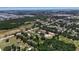 Aerial view of residences near the ocean with mature trees, green grass, and nearby conveniences at 2040 Edmondson Rd, Nokomis, FL 34275