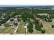 Establishing aerial shot of home and property in lush, wooded community at 2040 Edmondson Rd, Nokomis, FL 34275