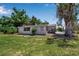 The house has a large backyard and wood details outside at 2040 Edmondson Rd, Nokomis, FL 34275