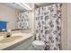 Bathroom with a floral shower curtain, mirror, sink, and a toilet at 2040 Edmondson Rd, Nokomis, FL 34275