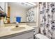 Bathroom with a sink, mirror, toilet, and a floral shower curtain at 2040 Edmondson Rd, Nokomis, FL 34275