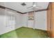 Bedroom with floral wallpaper border, window with sheer curtains, and a ceiling fan at 2040 Edmondson Rd, Nokomis, FL 34275