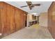 This dining room features wood paneled walls, with the kitchen area just beyond at 2040 Edmondson Rd, Nokomis, FL 34275
