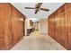 Spacious dining area featuring wood paneled walls and an overhead ceiling fan at 2040 Edmondson Rd, Nokomis, FL 34275