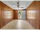 Dining room with wood-paneled walls featuring an exterior door offering outdoor views at 2040 Edmondson Rd, Nokomis, FL 34275