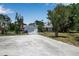Single-story home with attached garage, mature landscaping, and a long driveway at 2040 Edmondson Rd, Nokomis, FL 34275