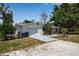 White single-story home featuring an attached garage and a well-manicured front yard at 2040 Edmondson Rd, Nokomis, FL 34275