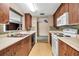 Functional kitchen featuring wood cabinets and an adjacent sink area with a backyard view at 2040 Edmondson Rd, Nokomis, FL 34275