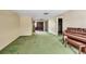 Spacious living room featuring wood paneling and connecting to other areas of the home at 2040 Edmondson Rd, Nokomis, FL 34275