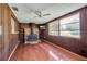 Cozy living room featuring a classic wood-burning stove and wood paneled walls at 2040 Edmondson Rd, Nokomis, FL 34275