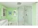 This bathroom features a glass enclosed shower, white subway tile, and modern fixtures for a clean, spa-like feel at 205 Elm Ave, Anna Maria, FL 34216