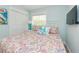 Bright bedroom features a comfortable queen-sized bed and ample natural light at 205 Elm Ave, Anna Maria, FL 34216