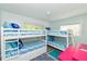Inviting bunk bedroom with two sets of bunk beds, perfect for Gathering and guests at 205 Elm Ave, Anna Maria, FL 34216