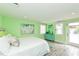 This bedroom offers a serene retreat with its white bedding, colorful art and easy access to the pool at 205 Elm Ave, Anna Maria, FL 34216