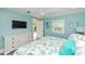 Bedroom with light blue walls, wood floors, and a TV, with access to the outdoors at 205 Elm Ave, Anna Maria, FL 34216