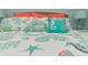 Comfortable bedroom décor with beach themed linens and accent pillows at 205 Elm Ave, Anna Maria, FL 34216