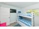 Charming bunk bedroom with a set of bunk beds, perfect for a vacation home or guest room at 205 Elm Ave, Anna Maria, FL 34216