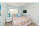 Cozy bedroom featuring a comfortable queen-sized bed and ample natural light from the window at 205 Elm Ave, Anna Maria, FL 34216