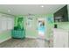 This bedroom features a turquoise dresser, access to the pool and cool-tone decor, creating a calming retreat at 205 Elm Ave, Anna Maria, FL 34216
