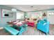 Cozy living room features coastal decor, blue accent chairs, a dining area and plenty of natural light at 205 Elm Ave, Anna Maria, FL 34216