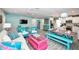 Bright living area with open concept dining and kitchen and colorful coastal furnishings at 205 Elm Ave, Anna Maria, FL 34216