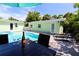 Outdoor dining next to the pool offering a relaxing atmosphere with seating, pool views, and lounge chairs at 205 Elm Ave, Anna Maria, FL 34216