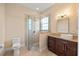 Neutral bathroom featuring glass shower, dark wood cabinets and granite counters at 20706 79Th E Ave, Bradenton, FL 34202