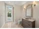 Stylish bathroom with marble countertop, decorative mirror, tile floors, and a walk-in shower at 20706 79Th E Ave, Bradenton, FL 34202