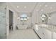 Bright bathroom featuring marble floors, dual sinks and a soaking tub at 20706 79Th E Ave, Bradenton, FL 34202