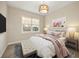 Cozy bedroom with a large window, neutral walls, and stylish furniture at 20706 79Th E Ave, Bradenton, FL 34202