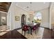 Elegant dining room featuring hardwood floors, modern chandeliers, and a large window view at 20706 79Th E Ave, Bradenton, FL 34202