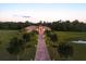 Beautiful estate featuring a grand entrance, manicured landscaping, and a long driveway at 20706 79Th E Ave, Bradenton, FL 34202