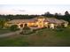 Aerial view of a sprawling estate home with a terracotta roof, mature landscaping, and an attached garage at 20706 79Th E Ave, Bradenton, FL 34202