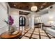 Elegant foyer with coffered ceilings, chandelier, and marble floors leading into the main living areas at 20706 79Th E Ave, Bradenton, FL 34202