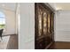 Hallway with detailed dark-wood display cabinet and light-colored wall paneling at 20706 79Th E Ave, Bradenton, FL 34202