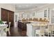 Spacious kitchen with double islands, white cabinets, granite counters and dark wood accents at 20706 79Th E Ave, Bradenton, FL 34202