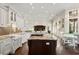 Expansive kitchen flowing into a living area, featuring a large island and ample natural light at 20706 79Th E Ave, Bradenton, FL 34202