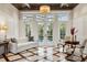 Living room with marble floors, coffered ceilings, a chandelier, French doors and backyard and pool views at 20706 79Th E Ave, Bradenton, FL 34202