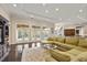 Elegant living area featuring a plush sofa, built-in media center, and access to outdoor patio at 20706 79Th E Ave, Bradenton, FL 34202