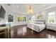 Spacious main bedroom with tray ceiling, chandelier, and lots of natural light at 20706 79Th E Ave, Bradenton, FL 34202