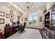 Bright office with dark wood floors, built-in shelves, and a large window at 20706 79Th E Ave, Bradenton, FL 34202